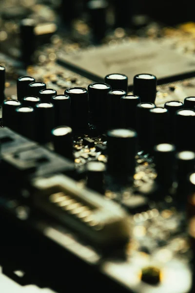 Computer motherboard closeup yellow gray color on dark background — Stock Photo, Image