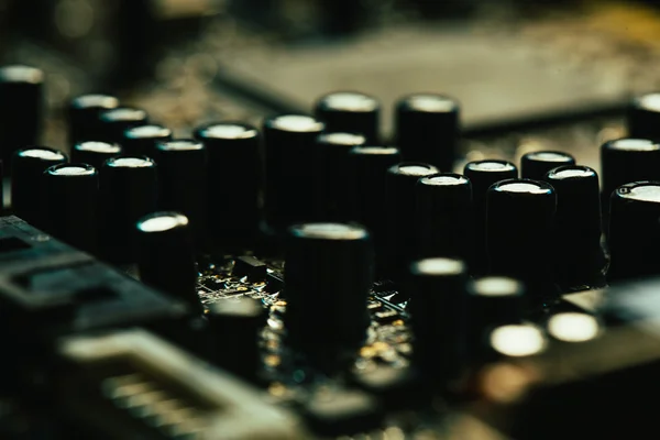 Computer motherboard closeup yellow gray color on dark background — Stock Photo, Image