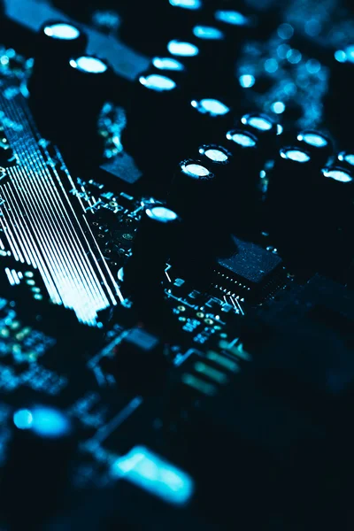 computer motherboard in blue dark background close-up