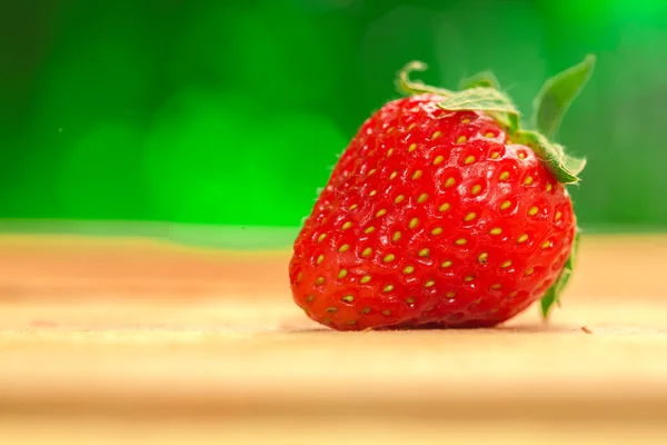 One berry fresh strawberries on a blurred background — Stock Photo, Image