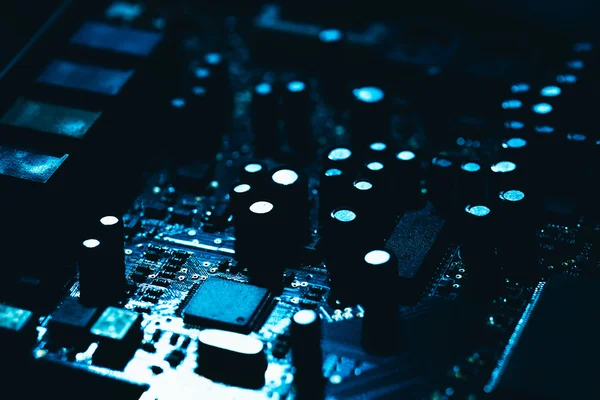 Computer motherboard in blue dark background close-up Stock Image