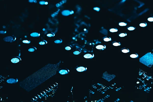 Computer motherboard in blue dark background close-up — Stock Photo, Image