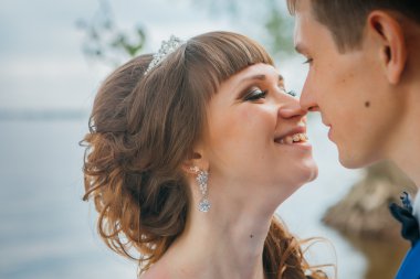 Gelin ve damat öpüşme ayakta doğa arka planda