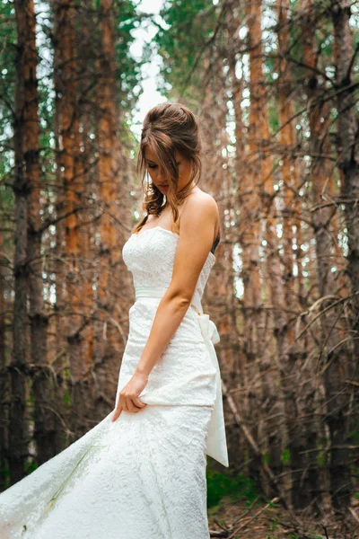 Bride with a tattoo on  background of leaves and forest backlight — Stock Photo, Image