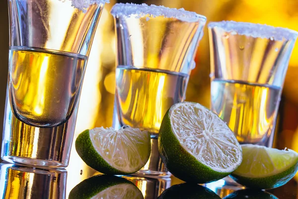 Stack of tequila with salt close up on blurred background — Stock Photo, Image