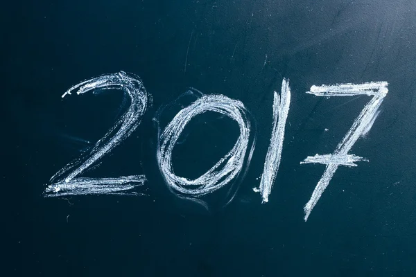 Year number 2017 written with the white chalk on the blackboard — Stock Photo, Image