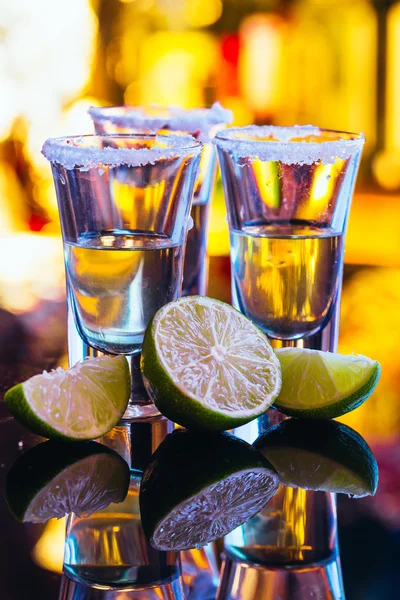 Stack of tequila with salt close up on blurred background — Stock Photo, Image