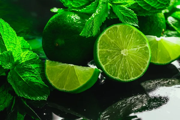 Gros plan vert menthe fraîche et citron vert sur fond sombre — Photo