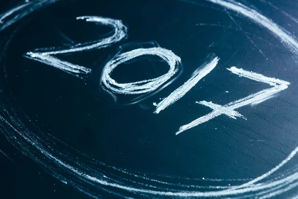 Year number 2017 written with the white chalk on the blackboard — Stock Photo, Image