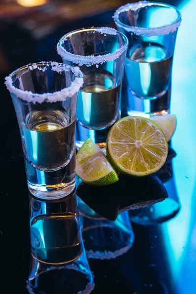 Stapel Tequila mit Salz in Großaufnahme auf verschwommenem Hintergrund — Stockfoto