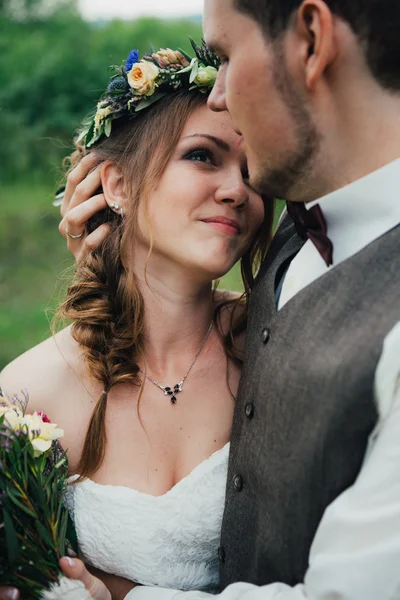 Porträtt av en brud och brudgum famn på bakgrunden lämnar skogen — Stockfoto