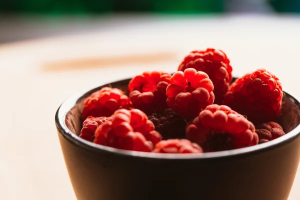 Raspberry in a cup on background of wooden boards — Stock Photo, Image