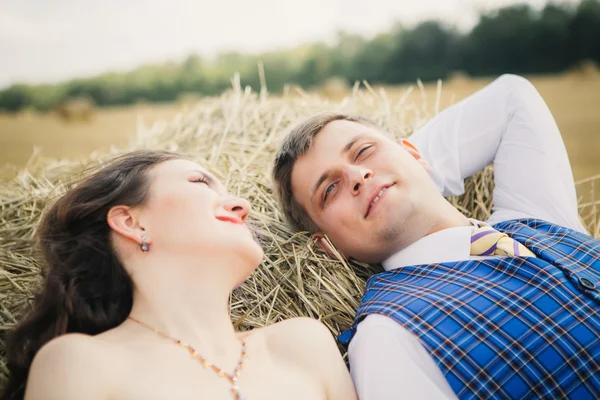 Novia y novio con velo cerca del heno — Foto de Stock