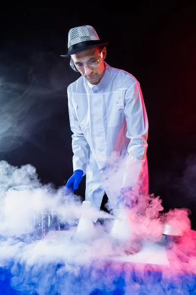 Smiling man scientist with dry ice — Stock Photo, Image