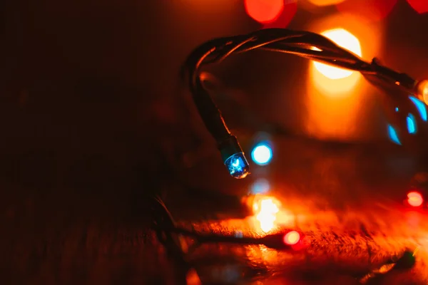 Christmas lights on wooden background. Selective focus — Stock Photo, Image