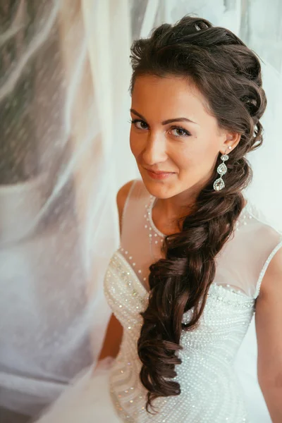 Beautiful young bride with wedding makeup and hairstyle in bedroom, newlywed woman final preparation for wedding. Happy Bride waiting groom. Marriage Wedding day moment. portrait soft focus — Stock Photo, Image