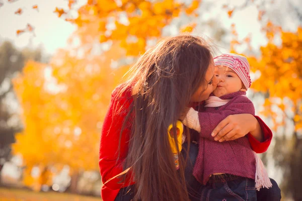 Mamma kysser hennes dotter i parken — Stockfoto