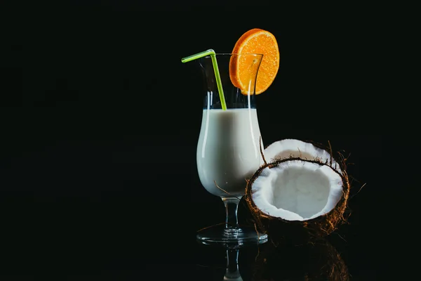 Pina Colada over black background, garnished with  coconut. — Stock Photo, Image