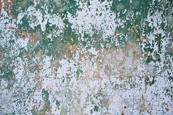 Grunge wall texture background. Paint cracking off dark wall with rust underneath. — Stock Photo, Image