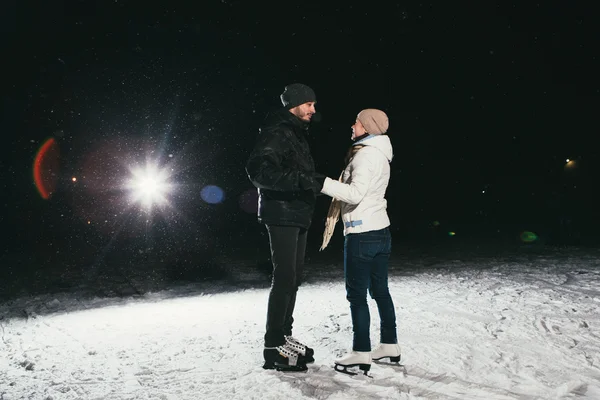 Pár bruslení venku na noc rybník — Stock fotografie