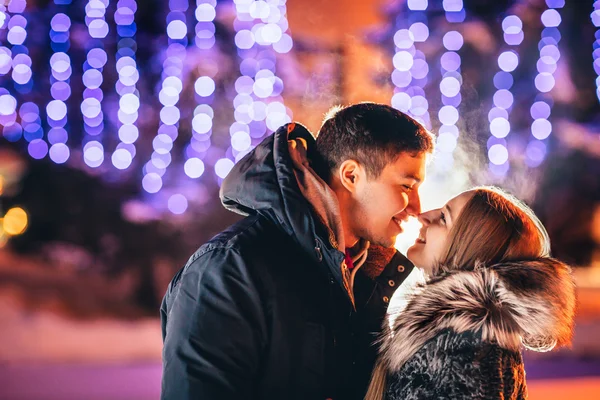 Young couple in love  outdoor filtered photo with flash flare — Stock Photo, Image