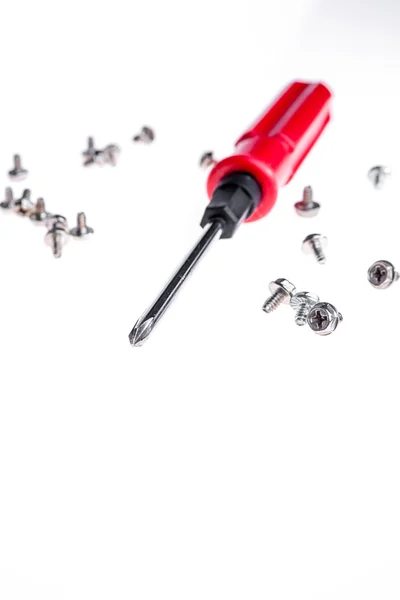 An isolated short of yellow handle screwdriver and screws — Stock Photo, Image