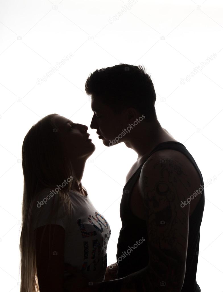 Passionate sensual attractive young couple in love, man caresses woman neck, isolated black and white portrait