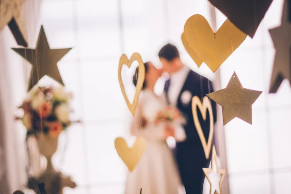 Close up de decorações de casamento. Concentre-se em decorações. Noiva e noivo no fundo . — Fotografia de Stock