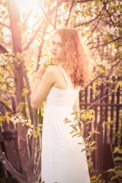 Beautiful young woman with gorgeous curly fair outdoors — Stock Photo, Image