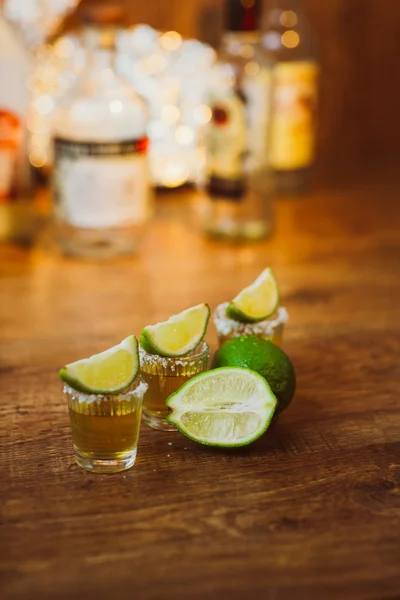 Tequila , lime and salt on wooden table — Stock Photo, Image