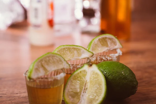 Tequila , lime and salt on wooden table — Stock Photo, Image