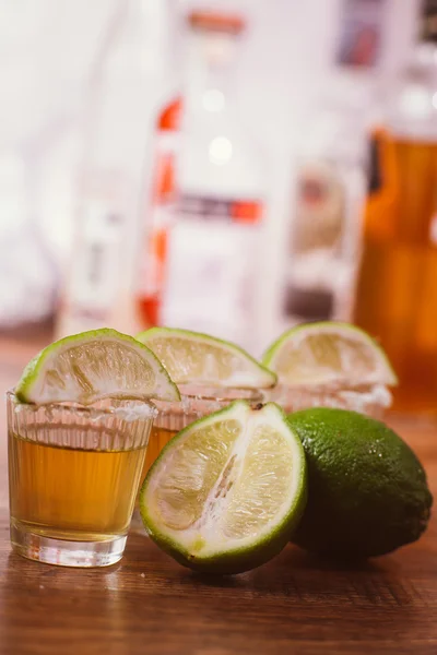 Tequila , lime and salt on wooden table — Stock Photo, Image