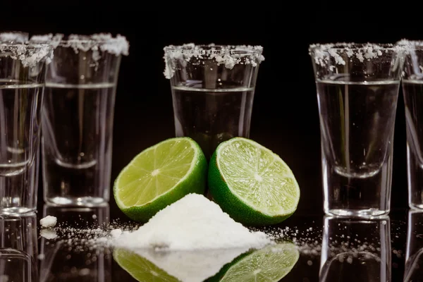 Tequila with lime on black background — Stock Photo, Image