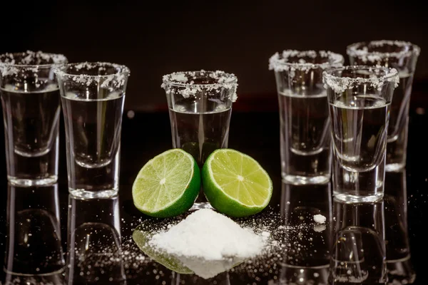 Tequila with lime on black background — Stock Photo, Image