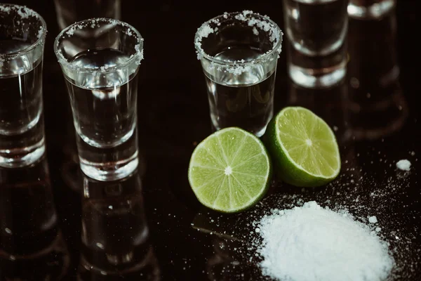 Tequila with lime on black background — Stock Photo, Image