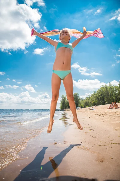 Little girl jumping high in water of a sea — Stock Photo, Image