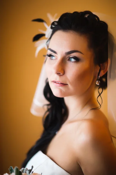 Beautiful young happy  bride standing near the window — Stock Photo, Image