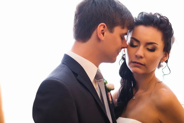 Beautiful young couple standing near the window — Stock Photo, Image