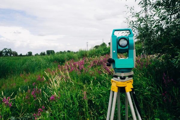 Blue surveying   equipment total station on a background of meadow — Stock Photo, Image