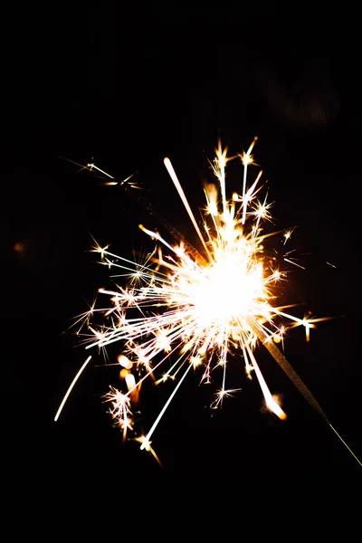 Bright Christmas sparkler closeup on a black background, soft focus — Stock Photo, Image