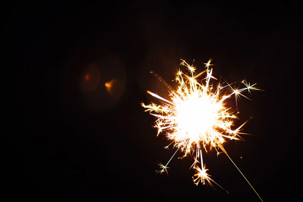 Bright Christmas sparkler closeup on a black background, soft focus — Stock Photo, Image