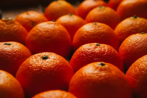 Many fresh tangerines closeup on the blurry background — Stock Photo, Image