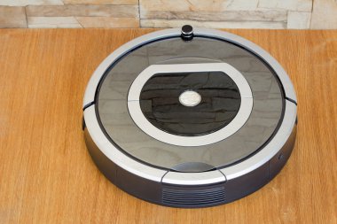 Robotics - the automated robot the vacuum cleaner. clipart
