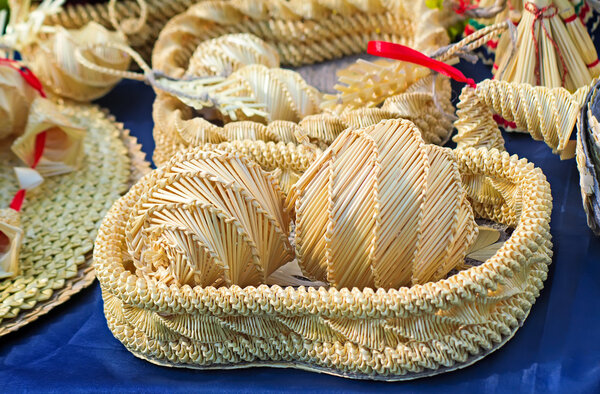 Original Souvenirs of woven straw are sold at the fair.