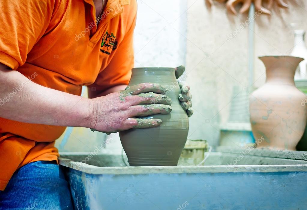 People at work: the production of ceramic vases on a Potter's wh