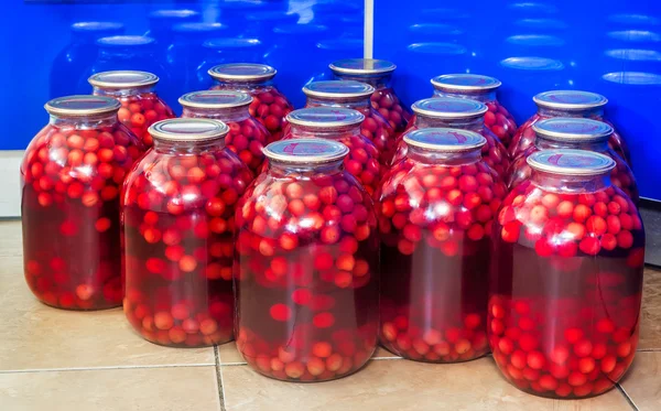 Home canning: large glass cylinders with cherry compote. — Stock Photo, Image