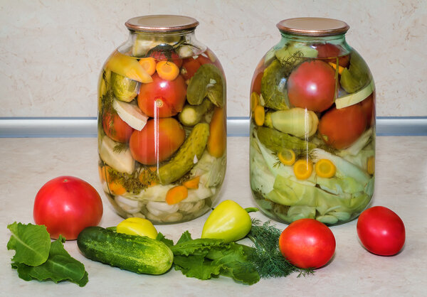 A variety of canned vegetables in glass jars.