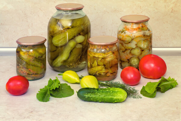 Canned cucumbers with spices in glass jars.