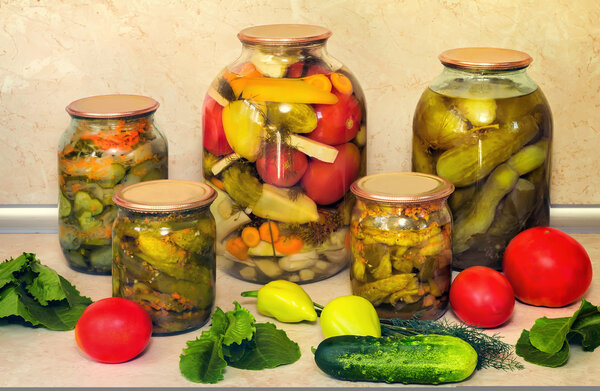 Canned cucumbers with spices in glass jars.