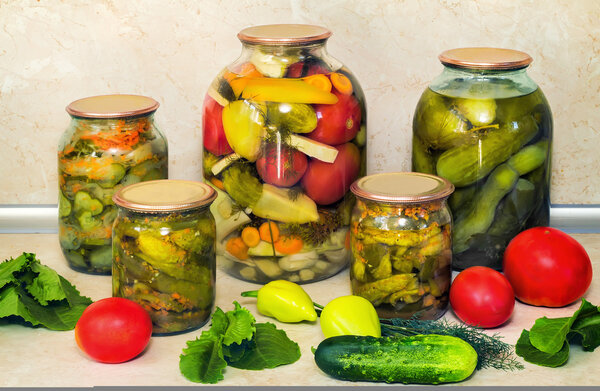 Canned cucumbers with spices in glass jars.